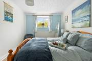 The pretty blue bedroom 1 has a super comfy king-size bed.