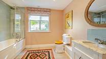 This gorgeous bathroom is perfect for a long soak after a busy beach day or a refreshing morning shower.