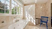 The spacious family bathroom with separate shower cubicle. 