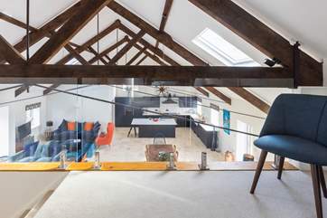 The mezzanine overlooks the living space and offers the perfect place for a holiday read or a quiet space if work calls.