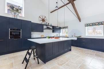 The super sleek kitchen invites you to create a culinary treat.