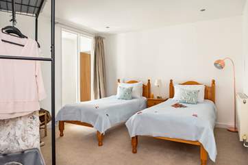 The twin bedded room is an internal room but the large glass panel gives the room plenty of light