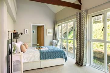 Bedroom One has a super comfy king-size bed and floor to ceiling windows letting the light flood in