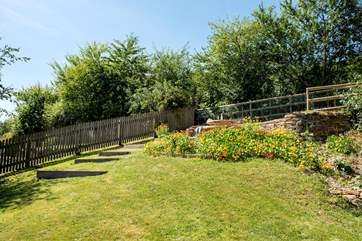 The dining terrace at the top of the garden is a lovely spot to enjoy meals alfresco style