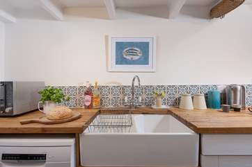 The kitchen has a proper country-style sink