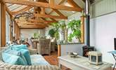 The conservatory has a dining-area as well as a sitting-area where you can snuggle up in front of the wood-burner. - Thumbnail Image