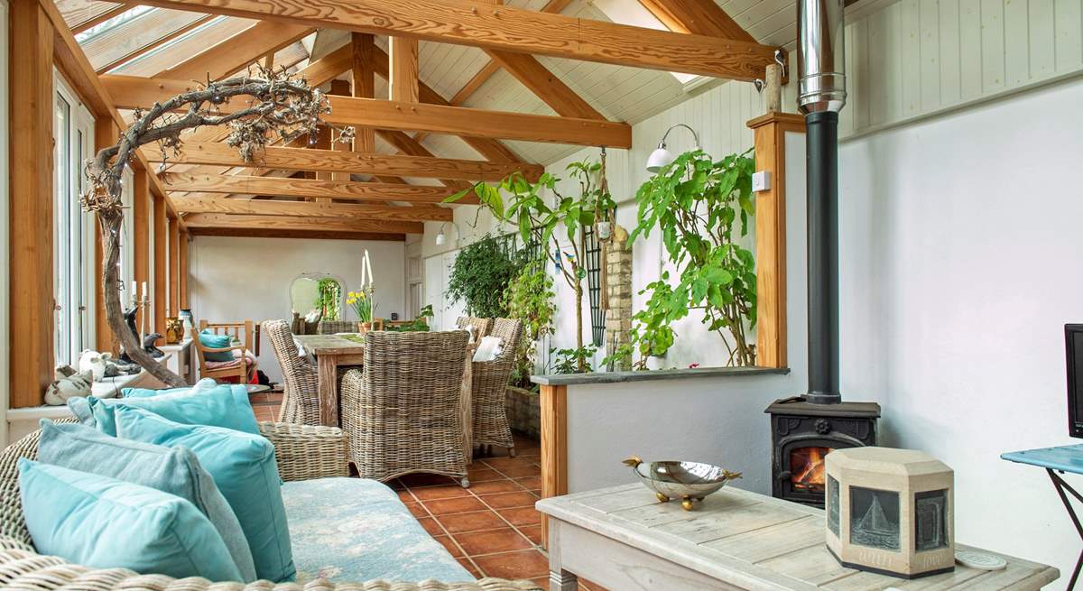 The conservatory has a dining-area as well as a sitting-area where you can snuggle up in front of the wood-burner.