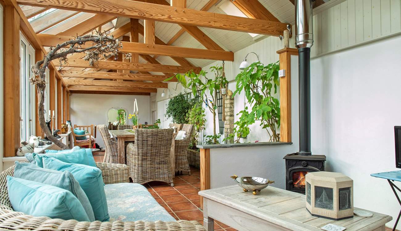 The conservatory has a dining-area as well as a sitting-area where you can snuggle up in front of the wood-burner.