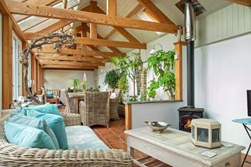 The conservatory has a dining-area as well as a sitting-area where you can snuggle up in front of the wood-burner.