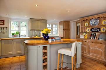 Take a pew at the kitchen island to keep the designated cook company.