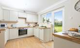 The kitchen has easy access to the rear garden and sits next to the dining-table for super sociable meals. - Thumbnail Image