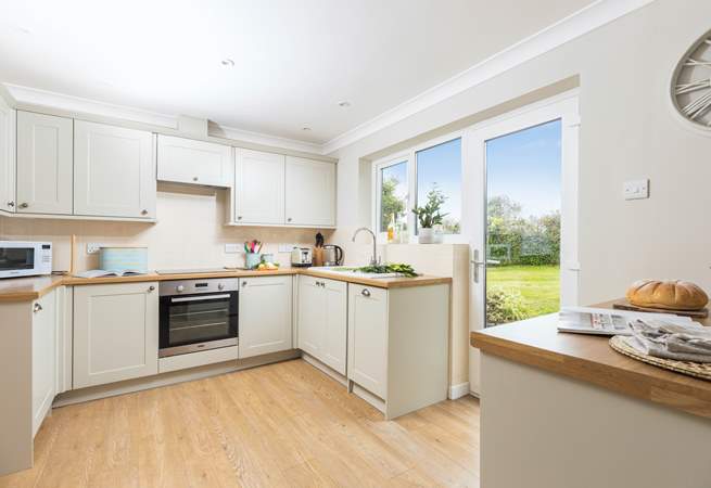 The kitchen has easy access to the rear garden and sits next to the dining-table for super sociable meals.