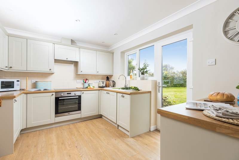 The kitchen has easy access to the rear garden and sits next to the dining-table for super sociable meals.