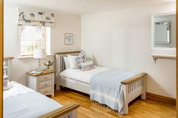 Pretty linens adorn the twin bedroom.
