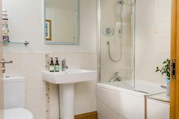 The family bathroom on the ground floor has a bath with shower over.