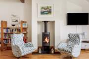 The fabulous open plan living space on the first floor has contemporary furnishings and a gorgeous wood-burner.