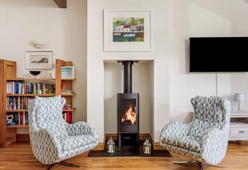 The fabulous open plan living space on the first floor has contemporary furnishings and a gorgeous wood-burner.