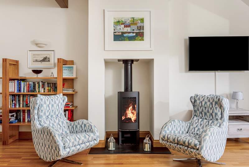 The fabulous open plan living space on the first floor has contemporary furnishings and a gorgeous wood-burner.