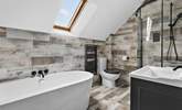 The gorgeous family bathroom is perfect for a long soak or a refreshing shower after a busy day. - Thumbnail Image