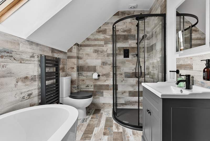 The stunning family bathroom has a gorgeous free-standing bath and shower.