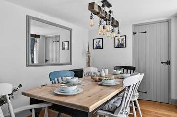 The dining-table with contemporary lighting is stunning.