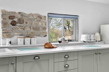 The windows from the kitchen overlook surrounding countryside.