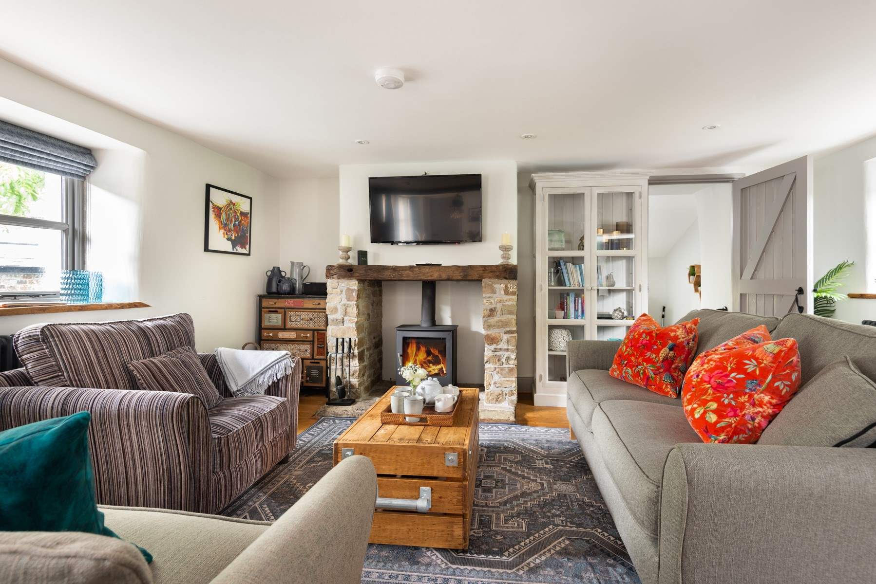 Relax in front of the wood-burner and watch a movie on the Smart TV. Please note, the striped chair has now been replaced with a velvet teal coloured chair.