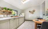 The super sleek kitchen has a sweet table and chairs for two, the perfect place to sit and chat with the chef. - Thumbnail Image
