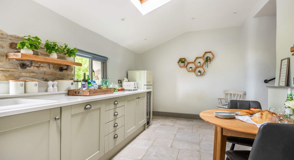 The super sleek kitchen has a sweet table and chairs for two, the perfect place to sit and chat with the chef.