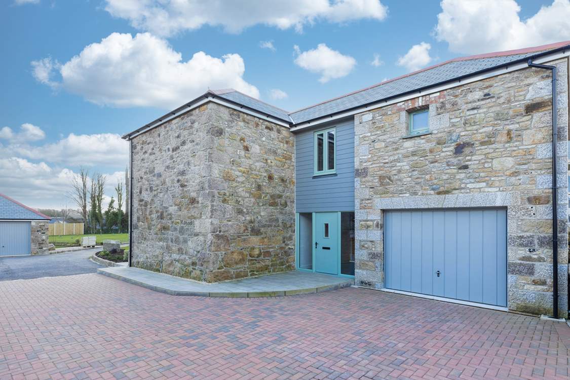 There is ample parking with an integrated garage and room for four cars on the drive.