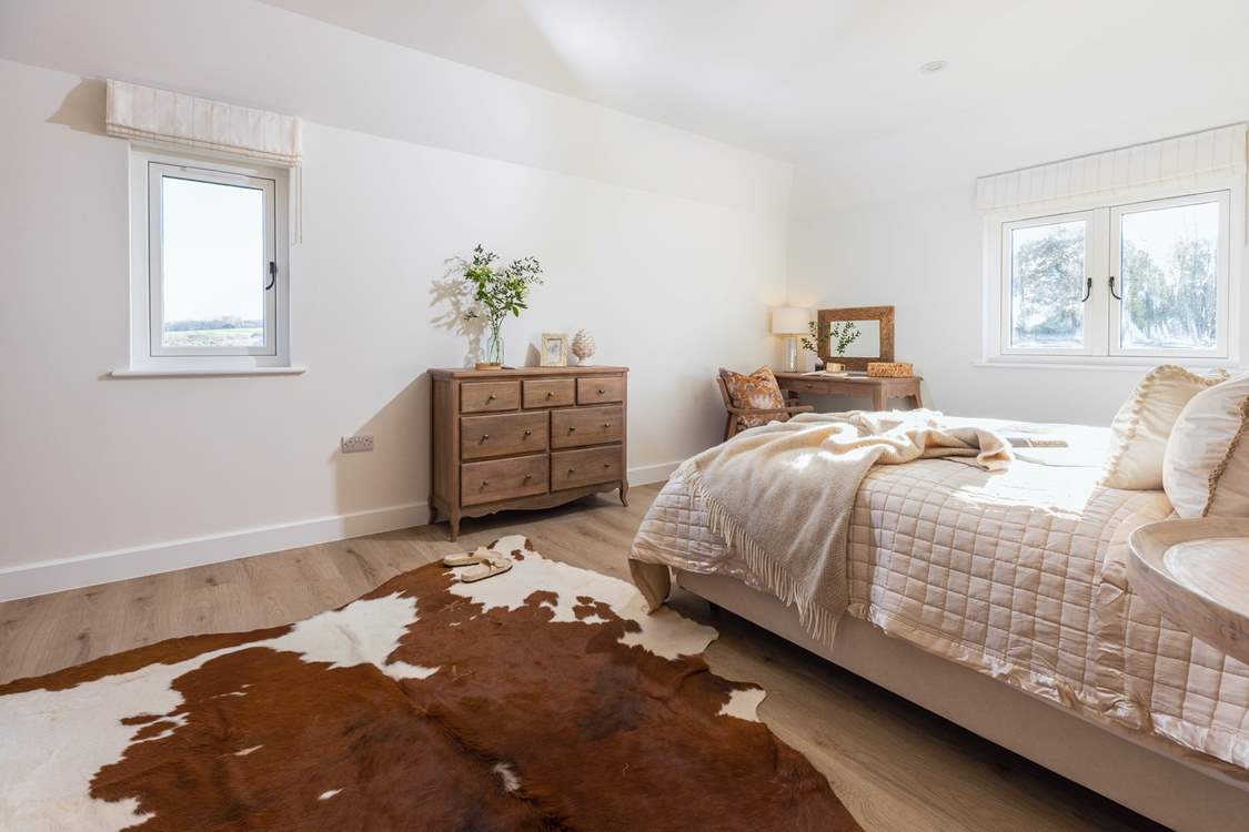 The principal bedroom has an en suite shower-room and views over the church and rolling countryside beyond.