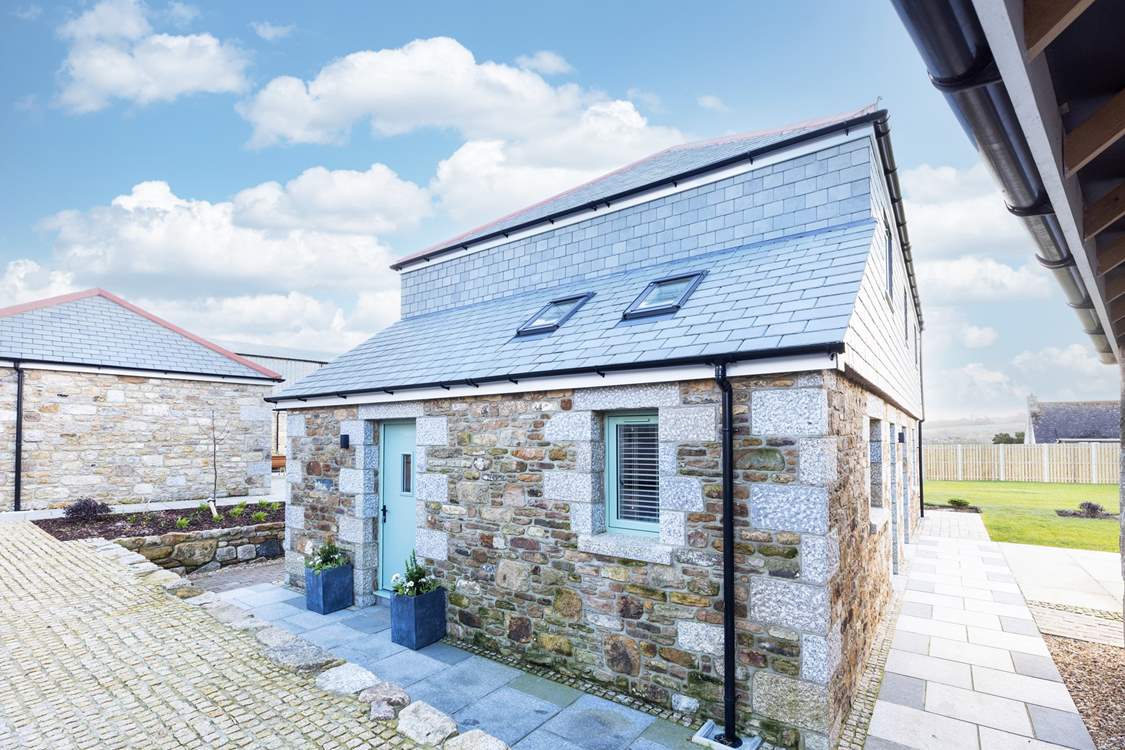 Two steps lead you to The Old Stables from the carport and drive.