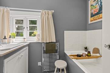 The family bathroom on the first floor has a bath with hand held shower over.
