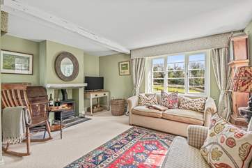 One of two cosy sitting-rooms with dual-aspect views across the surrounding gardens.