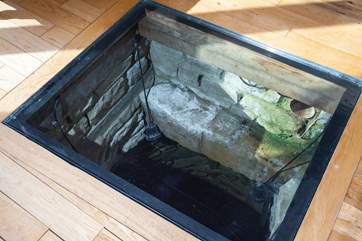 Extraordinary stone well, covered by protective glass; a real statement and story behind Stonewell Barn's history.