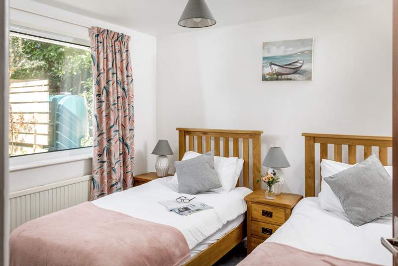 The pretty twin bedroom overlooks the peaceful back garden.
