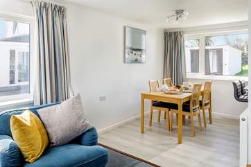 The open plan living space flows from sitting-area to dining space and kitchen.