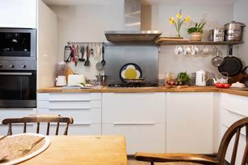 The well-designed kitchen/diner has a traditional farmhouse table and chairs, perfect for sociable dining.