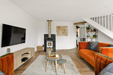 With a TV and wood-burner, the sitting-room is beautifully presented.