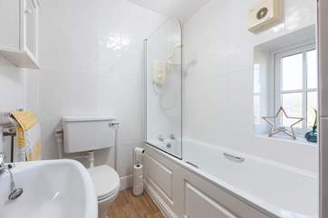 The family bathroom has a bath with shower over.