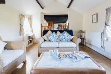 A small flight of stairs leads down to the cosy living-room.