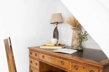 The snug has a desk, ideal for writing a quick postcard.