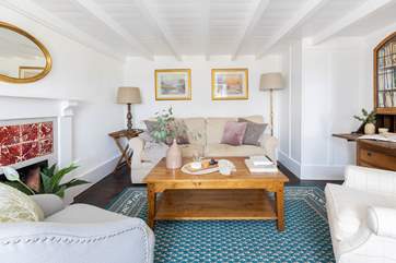 The original fireplace and restored furniture add charm to this fabulous cottage.