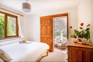 This charming bedroom overlooks the garden and leads through to the conservatory (Bedroom 2).
