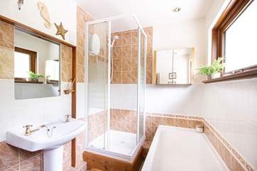 The family bathroom has an electric shower and separate bath.