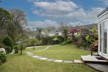 The lawned garden has a stunning border with a plethora of sub-tropical plants.