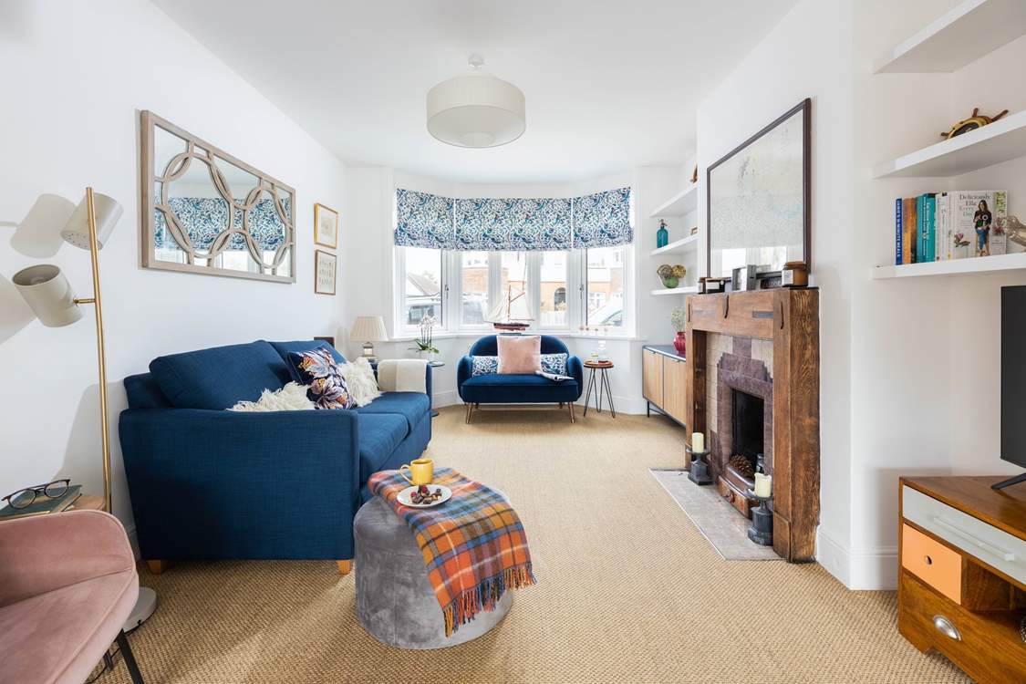 Light and bright, the spacious living area has a fabulous original fireplace.