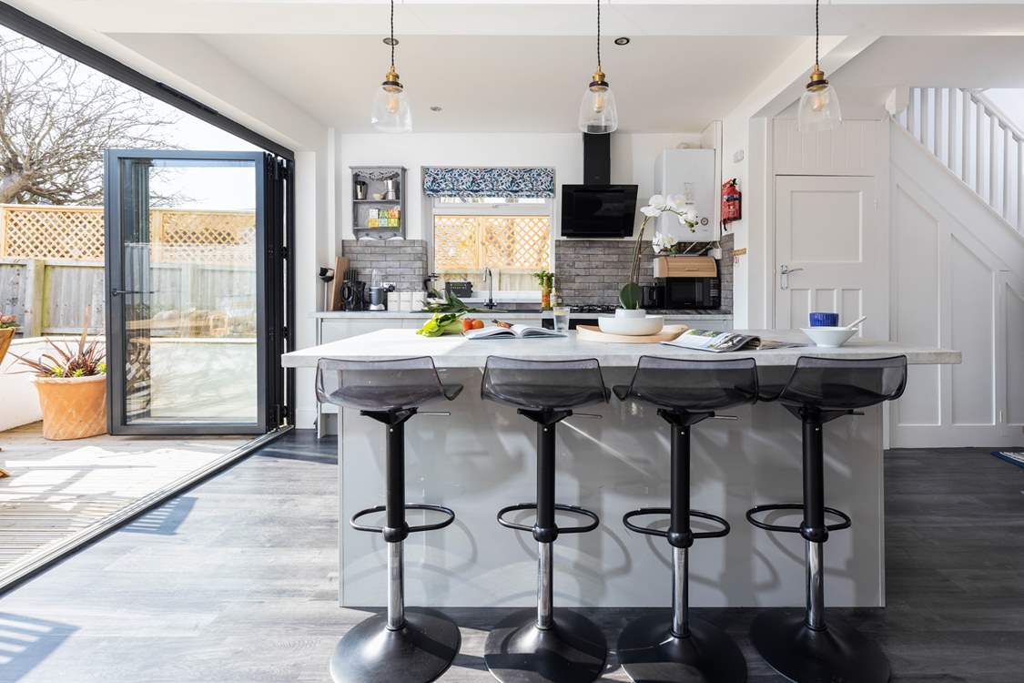 Bi-fold doors lead from the beautifully styled kitchen into the garden.