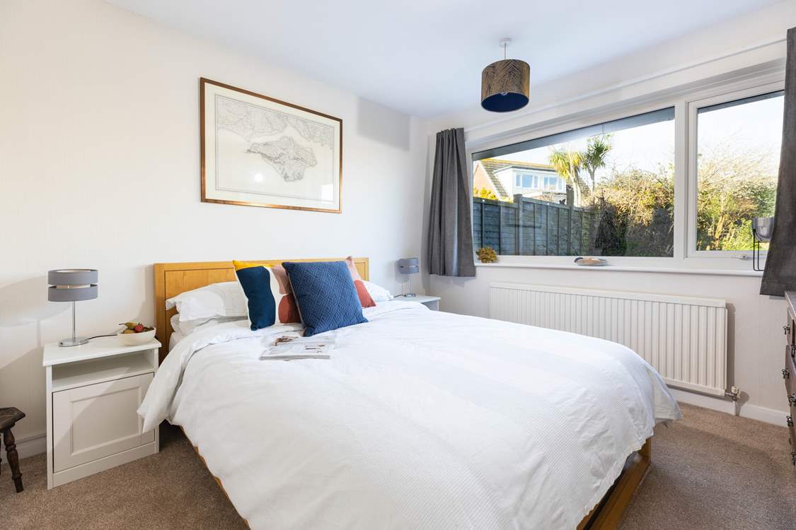 The comfy ground floor bedroom with a lovely view of the garden. All bedrooms provide blackout curtains.