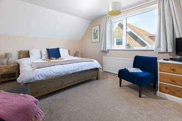 The spacious main bedroom, in the distance from this window you can see the sea.